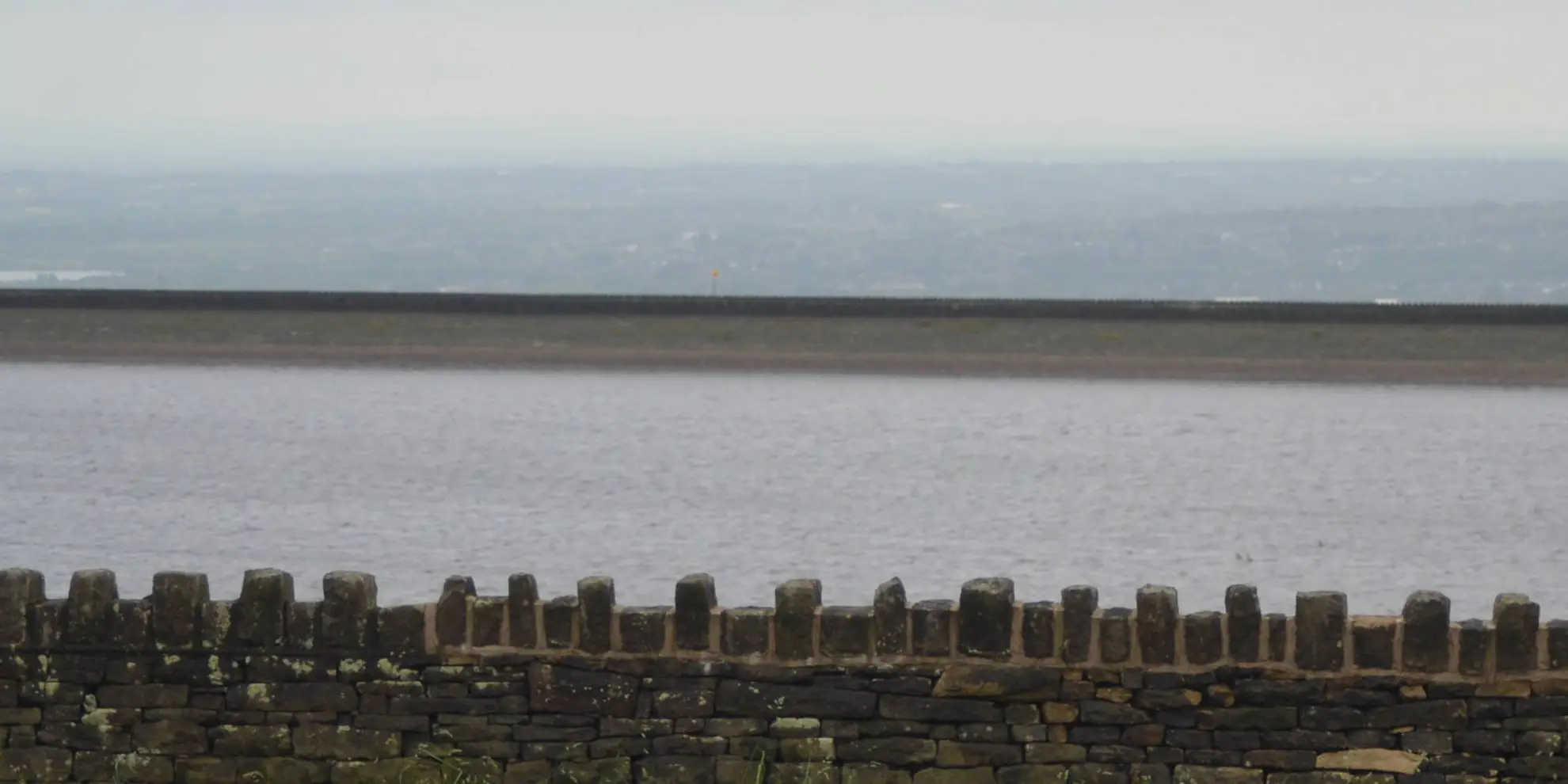 An image depicting the trail Scout Moor from Ashworth Moor Reservoir and its surrounding area.