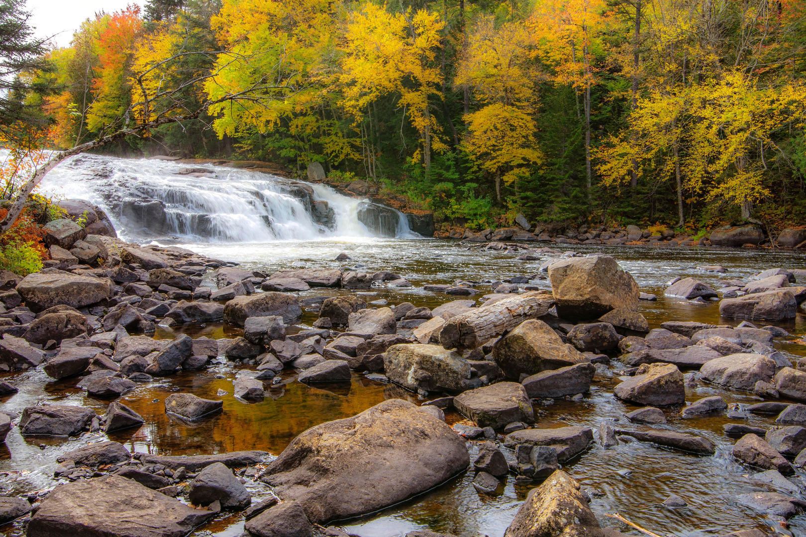 An image depicting the trail Buttermilk Falls and its surrounding area.