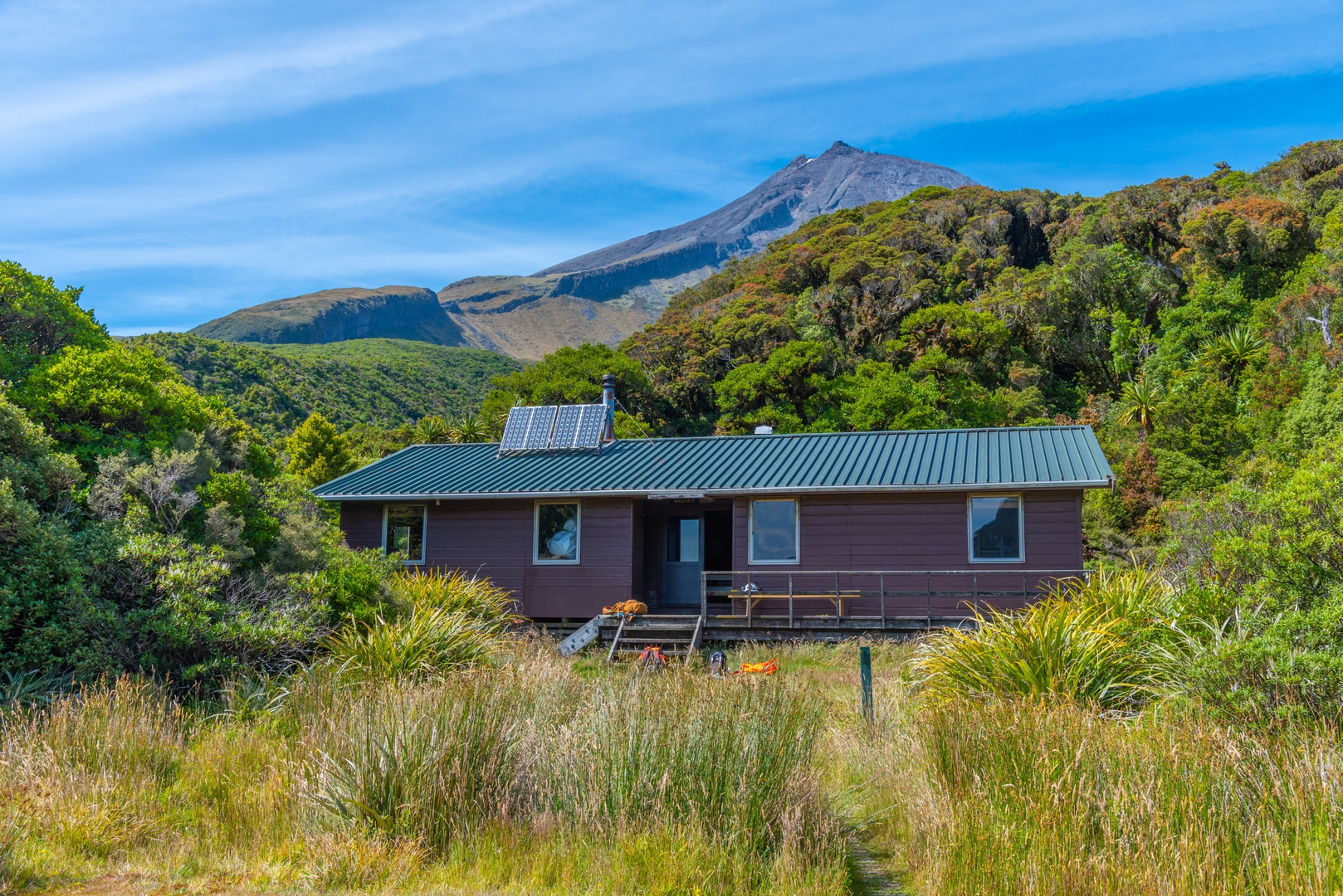 An image depicting the trail Pouakai Range Tramping Tracks - Mangorei Track to Pouakai Hut and its surrounding area.
