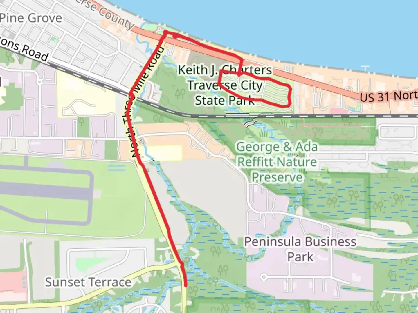 An image depicting the trail Traverse City State Park and Three Mile Trail and its surrounding area.