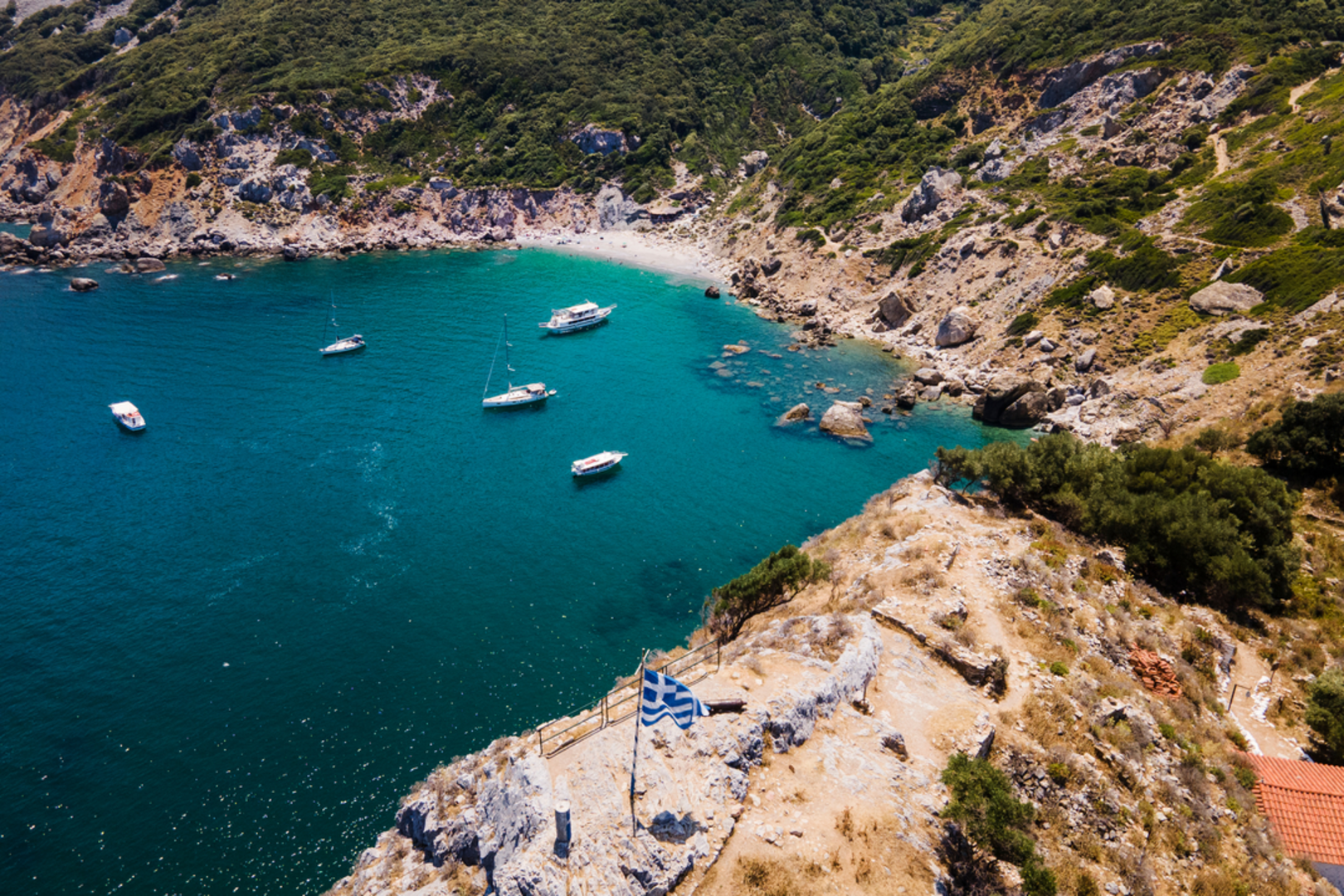 An image depicting the trail Evangelistria Monastery - Agios Charalambos Trail and its surrounding area.