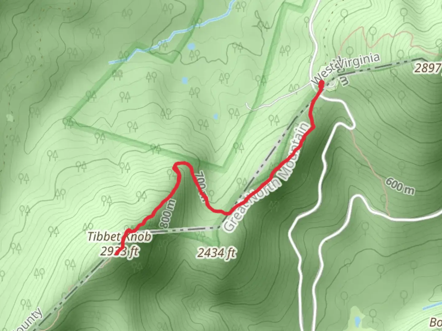 An image depicting the trail Tibbet Knob Trail from Wolf Gap and its surrounding area.