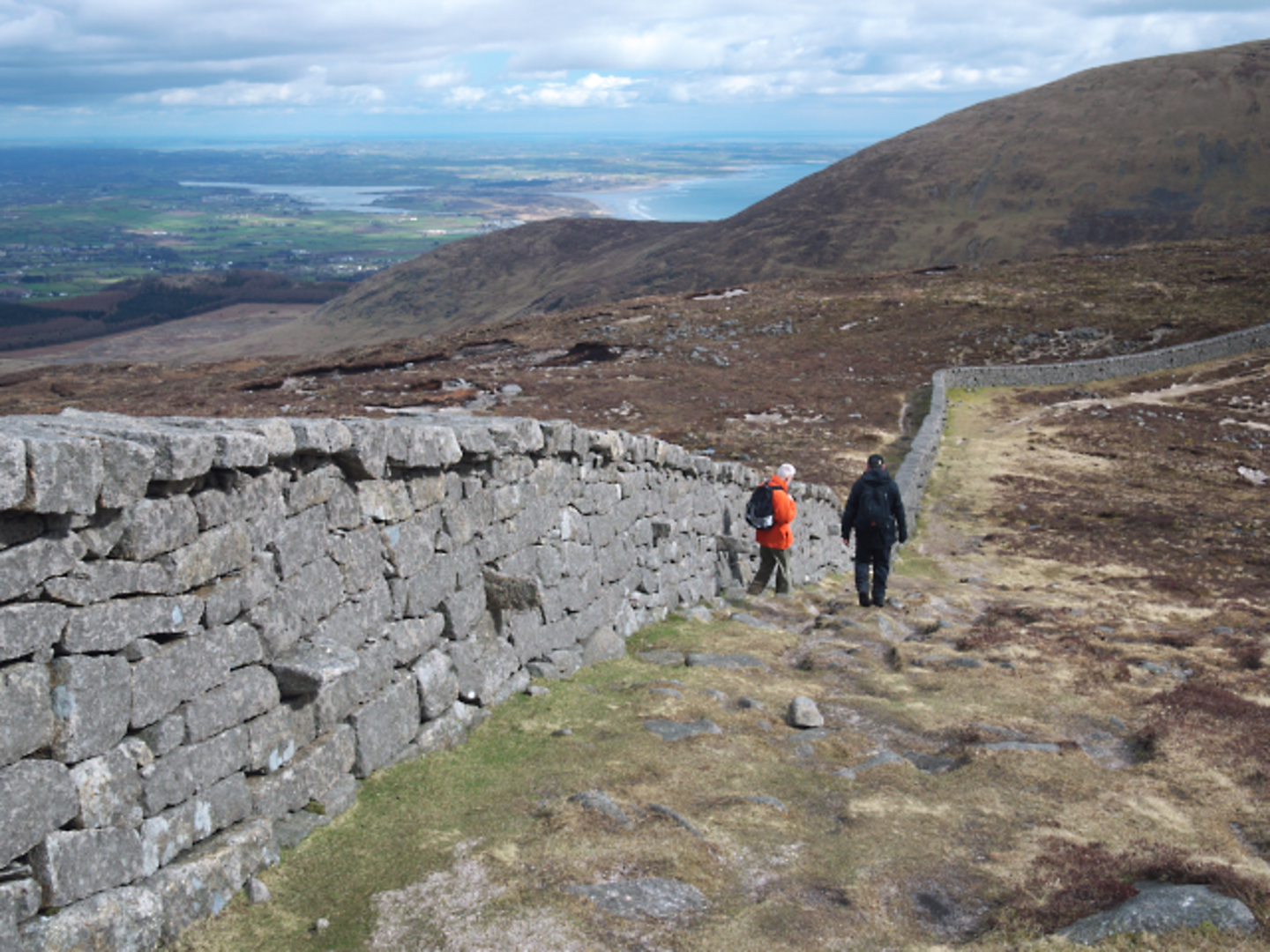 An image depicting the trail Slievenaglogh and Slieve Donard Peaks Walk and its surrounding area.