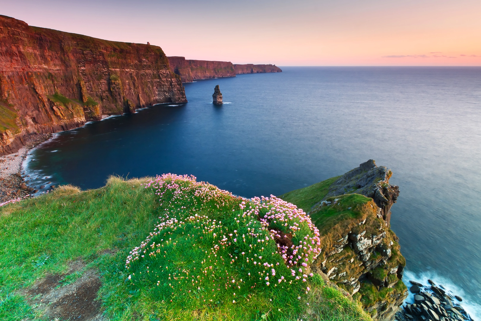 An image depicting the trail Cliffs of Moher and its surrounding area.