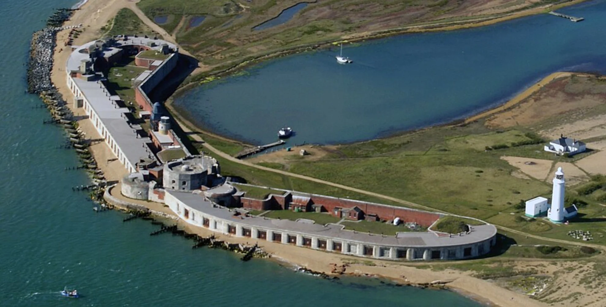 An image depicting the trail Hurst Point Lighthouse and its surrounding area.