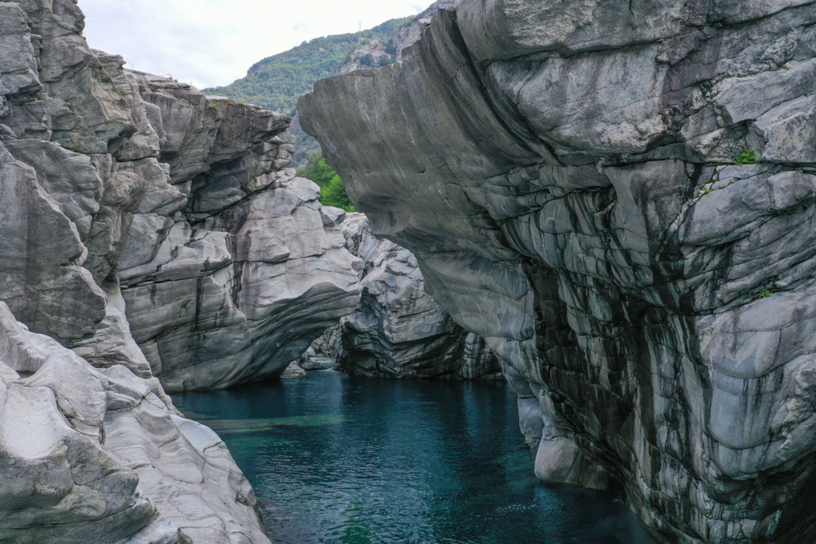 An image depicting the trail Castelliere Ruins from Ponte Brolla and its surrounding area.
