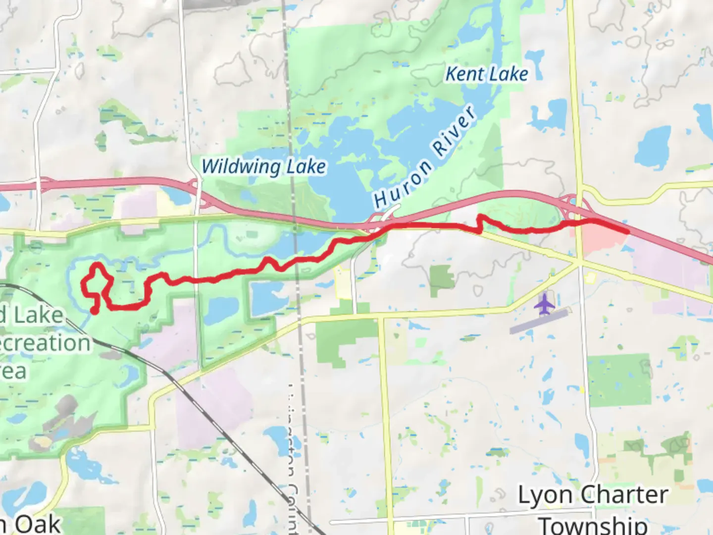 An image depicting the trail Kent Lake Beach Road to Huron Valley Trail and its surrounding area.