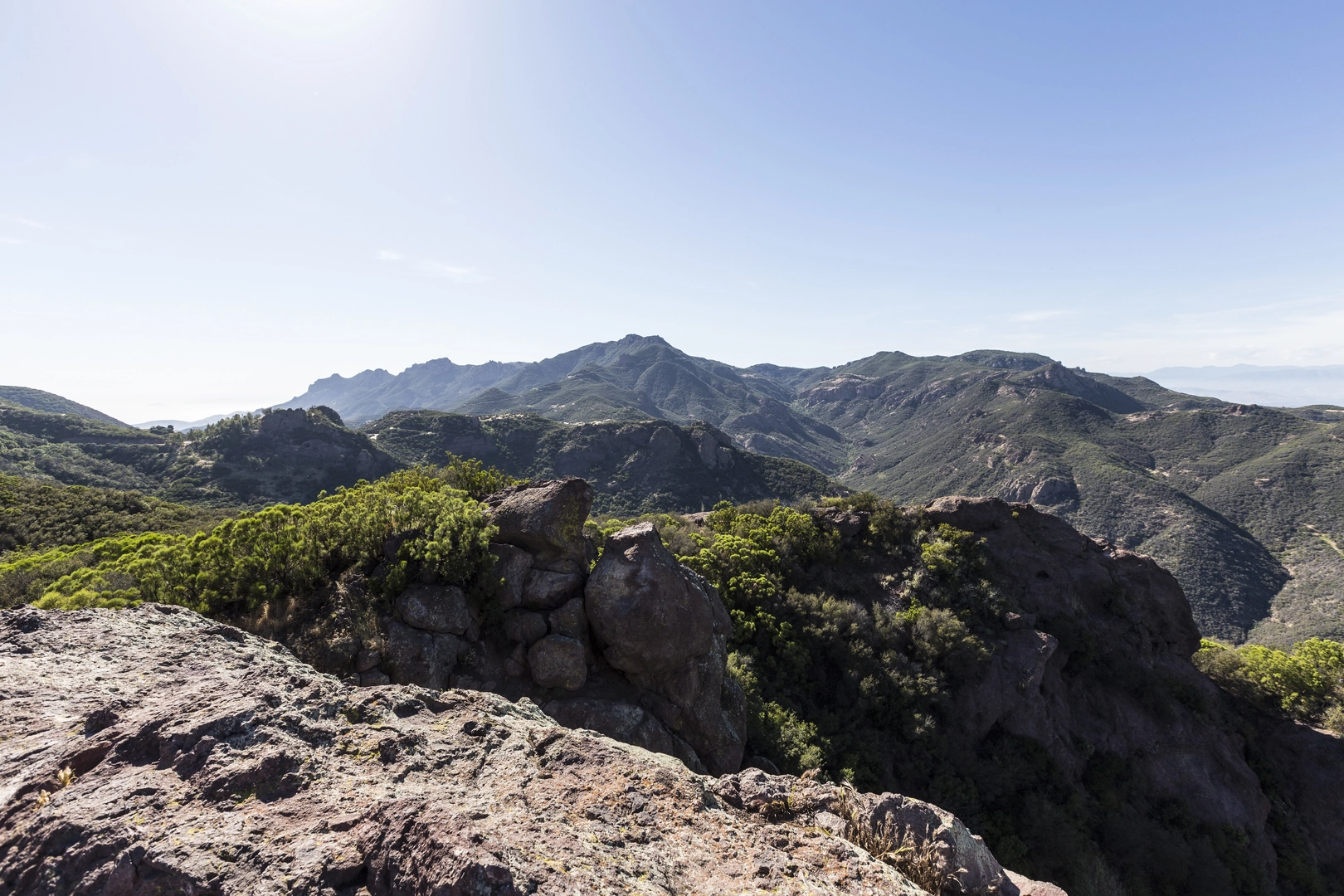 An image depicting the trail Sandstone Peak and Tri Peaks via Ranch OverLook Trail and its surrounding area.