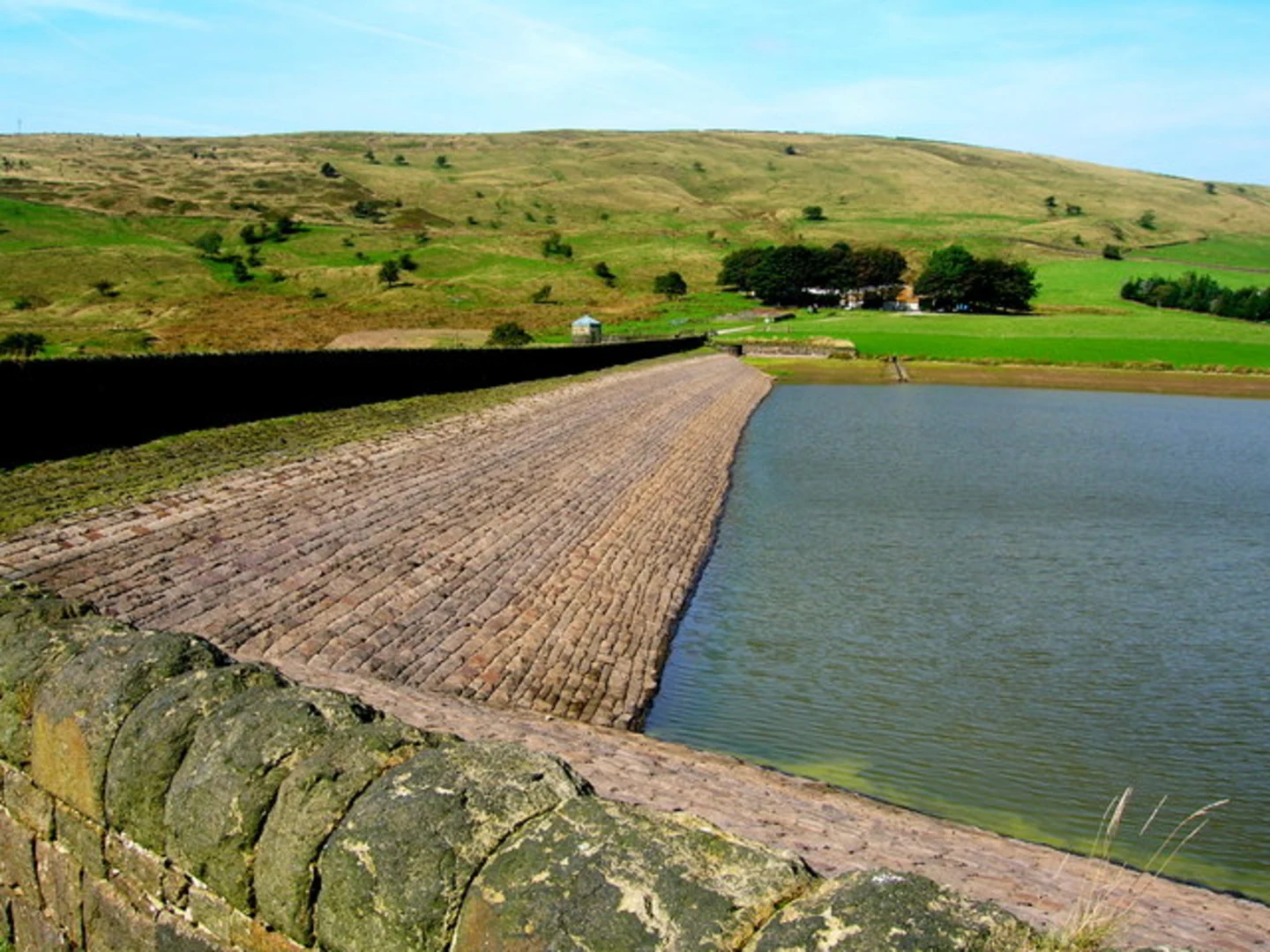 An image depicting the trail Delph, Castleshaw and Greenfield Loop via Upper Castleshaw Reservoir and its surrounding area.
