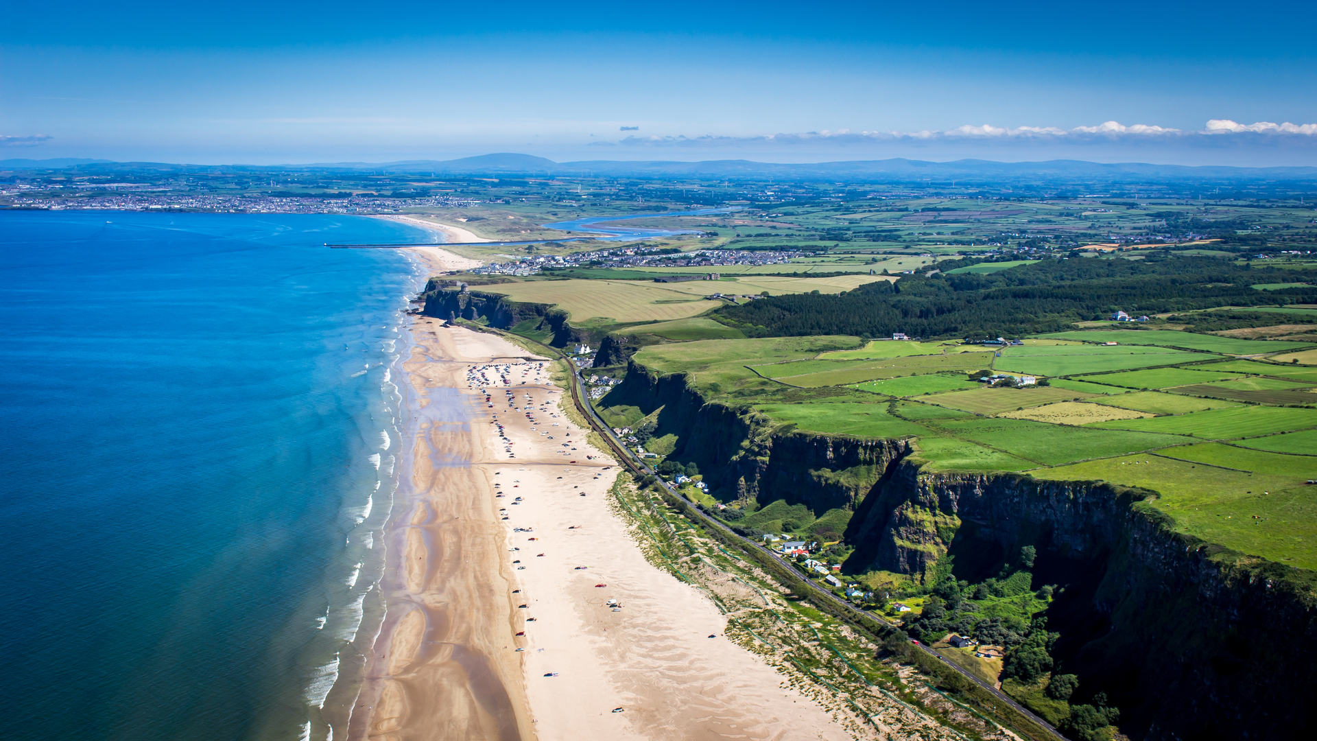 An image depicting the trail Benone Strand and its surrounding area.
