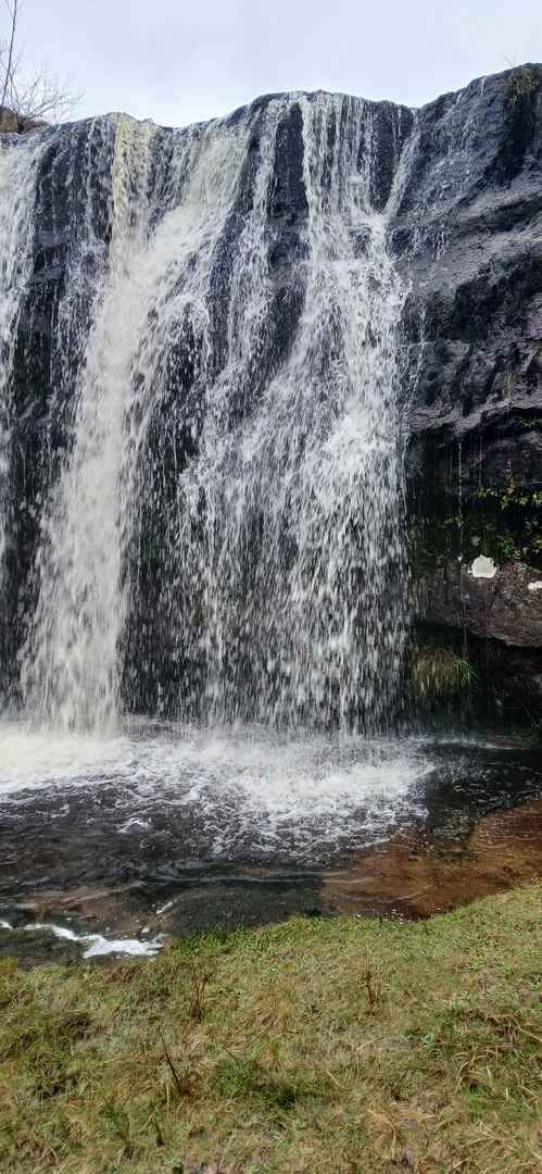 An image depicting the trail Knockmeals Doon waterfall and its surrounding area.